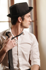 Tired of his tie. Handsome young stylish men