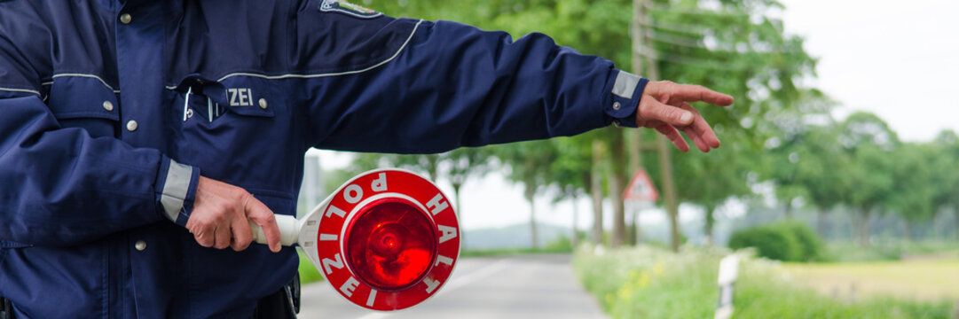 polizist winkt autofahrer aus dem verkehr