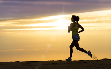 Fototapeta na wymiar Athlete running at sunset on beach
