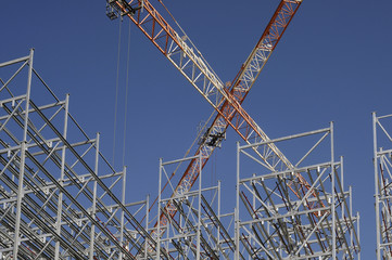 Fototapeta na wymiar Steel structure of a high rack warehouse and a crane during cons