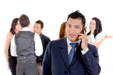 Businessman using a cellphone with peers
