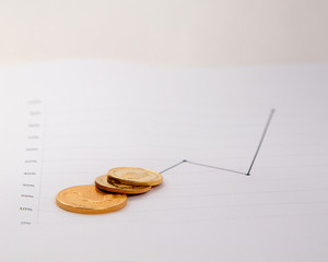 Gold coins on financial chart