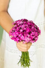 Girl holding a bouquet of carnations