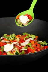 Vegetable ragout in wok, isolated on black