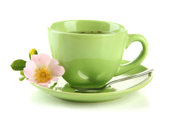 Cup of herbal tea with hip rose flower, isolated on white
