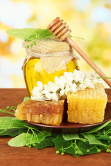 Jar of honey with flowers of lime and acacia,