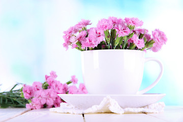 Many small pink cloves in cup