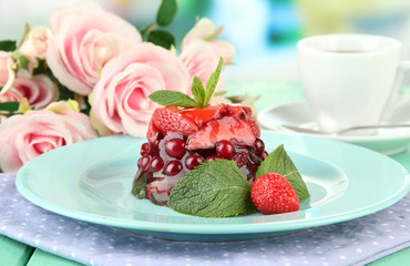 Tasty jelly dessert with fresh berries, on bright background