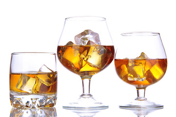 Brandy glasses with ice isolated on white