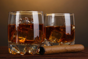 Brandy glasses with ice and cigar