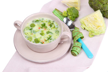 Cabbage soup in plate on napkin isolated on white