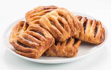 group flaky pastries filled with jam on white plate