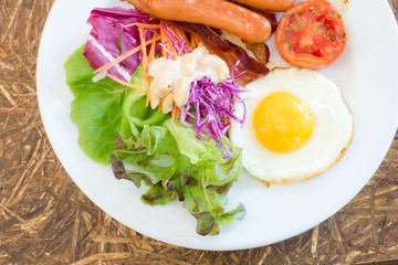 Fried eggs with sausages and Grilled Tomato with breakfast