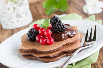 Chocolate Pancake with berries and honey.