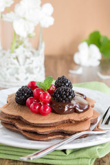 Chocolate Pancake with berries and honey.