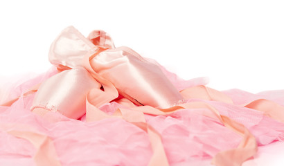 ballet shoes on a pink cloth isolated