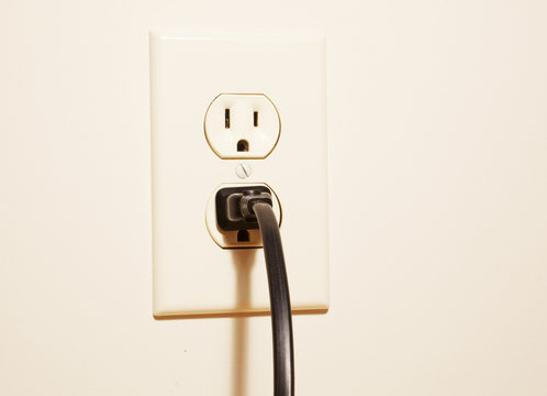 A plug connected to an electrical outlet