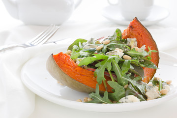 Pumpkin salad with arugula and cheese.