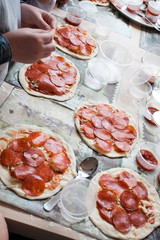 children arms making doughs at pizza workshop