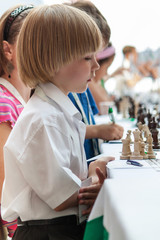 Young boy plays chess