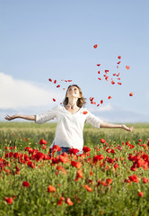 Young casual woman relaxing in poppy field