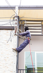 Electrician working on a pole