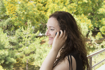 woman talking on a cell phone while overlooking the garden