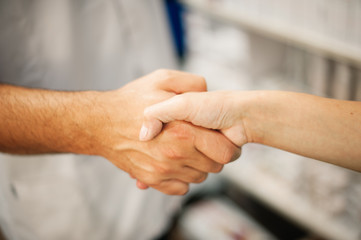 handshake man woman at pharmacy