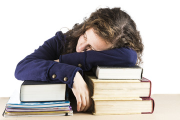 Teen sleeping on her books