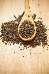 Black pepper peas on a wooden spoon