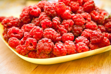 Raspberries on a yellow plate