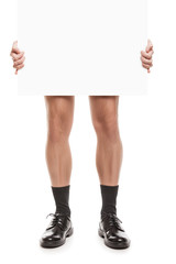 Naked man in black socks and shoes holding blank placard