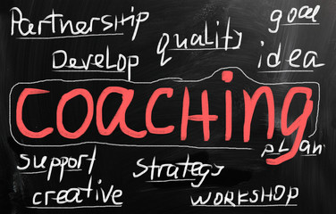"Coaching" handwritten with white chalk on a blackboard