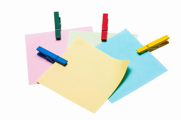 reminder note with color clothes pins on white background