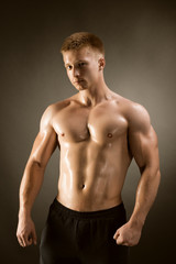 Fototapeta premium Healthy muscular young man posing in studio