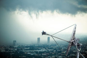 Antenna communication satellite dish with storm background