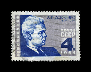Dovzhenko Alexander, famous ukrainian cinema producer, ussr, circa 1964. vintage postal stamp isolated o black background.