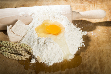 Pile of flour, rolling pin and wheat