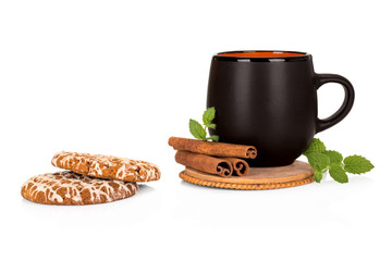 Black tea cup with cinnamon and cookies on white background