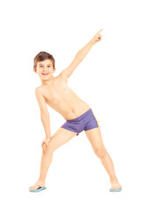 Obraz premium Full length portrait of a boy in swimming shorts gesturing with