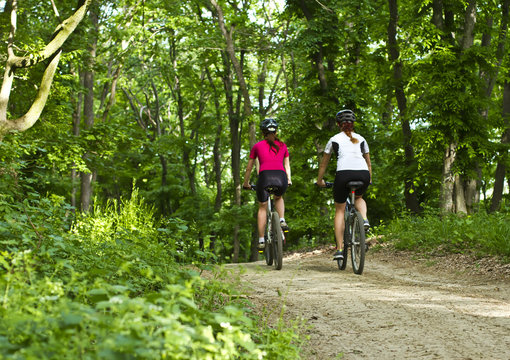 girls  biking in the forest