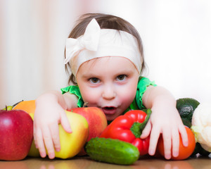 Happy Kid with vegetables and fruits.