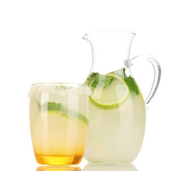 Citrus lemonade in pitcher and glass isolated on white