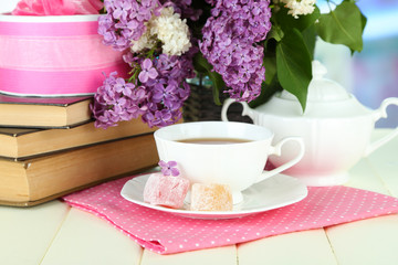 Composition with beautiful lilac flowers, tea service