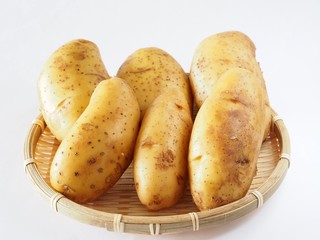 Potato isolated in bamboo basket on white background