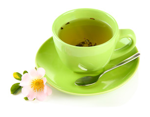 Cup of herbal tea with hip rose flower, isolated on white