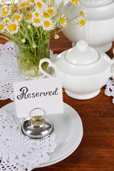 Table setting with chamomiles on wooden table