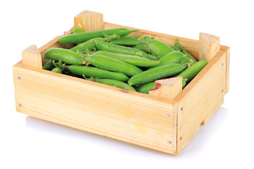 Sweet green peas in wooden box isolated on white