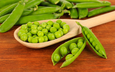 Sweet green peas on wooden background