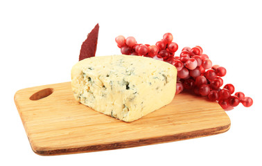 Tasty blue cheese and grape on cutting board, isolated on white